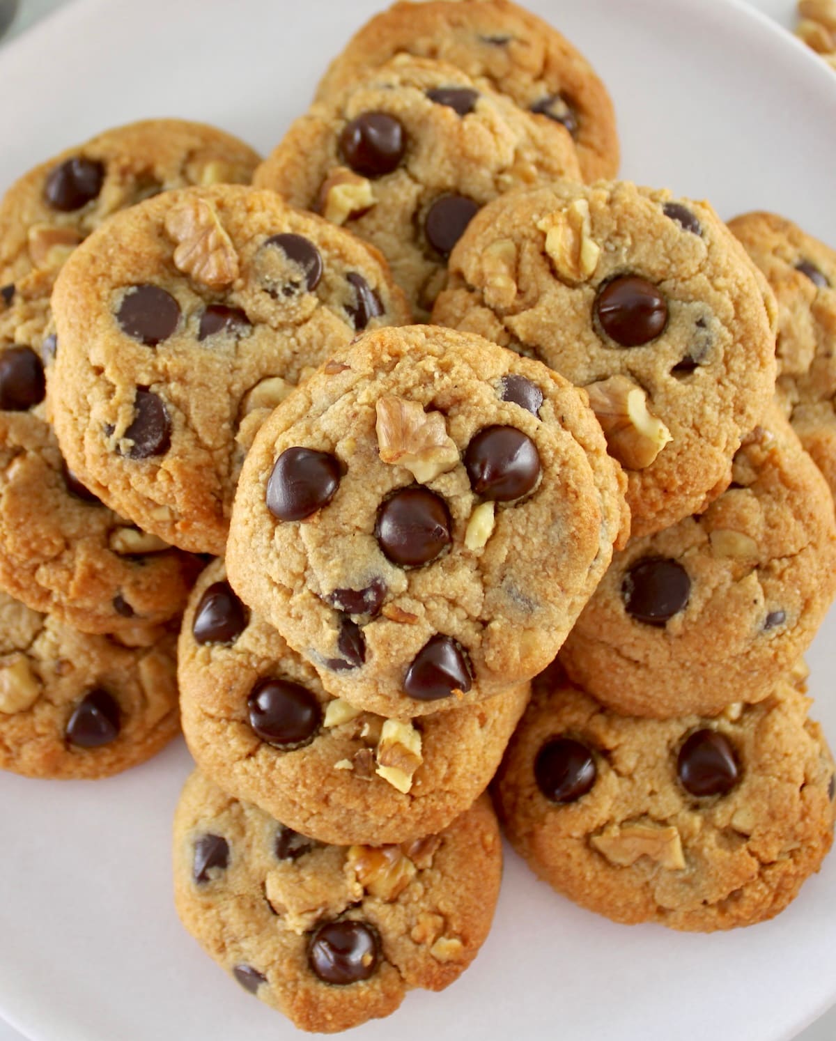 overhead view of Chocolate Chip Walnut Cookies stacked on plate