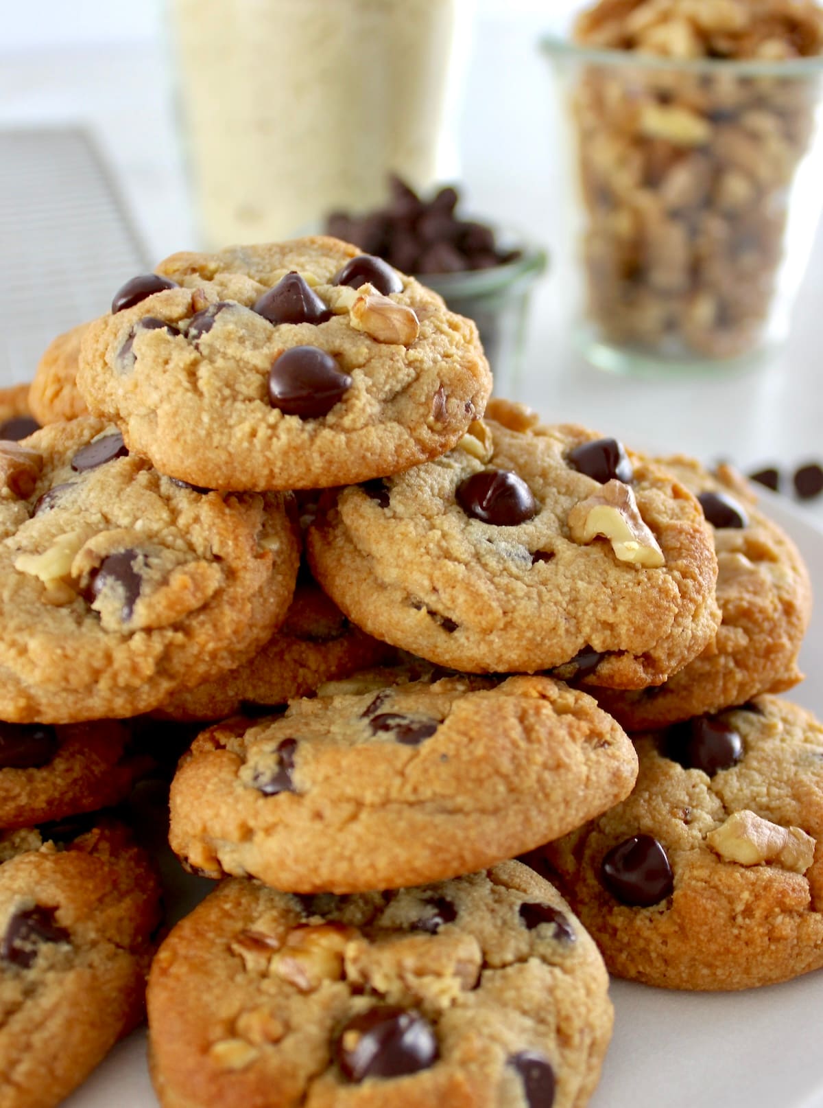 closeup of Chocolate Chip Walnut Cookies stacked up on white plate