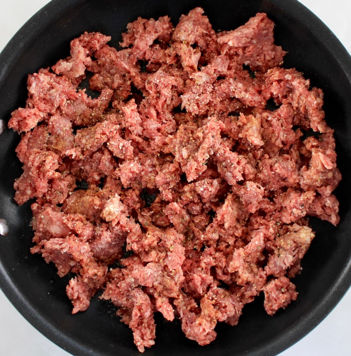 raw ground beef in skillet