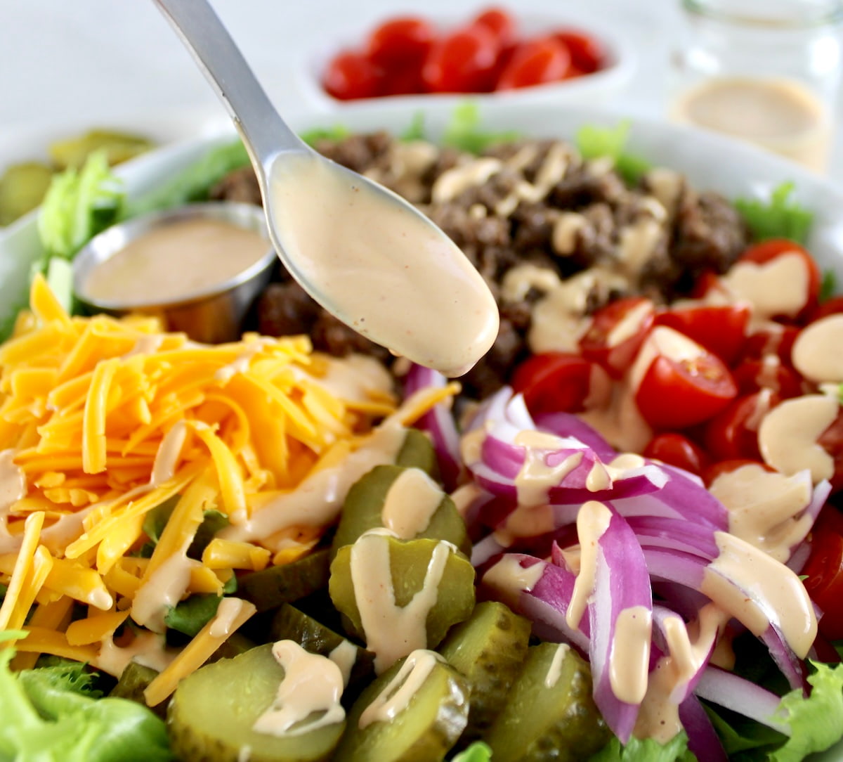 Burger Bowl with sauce being spooned over the top