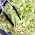 Buttered Cabbage in skillet with tongs