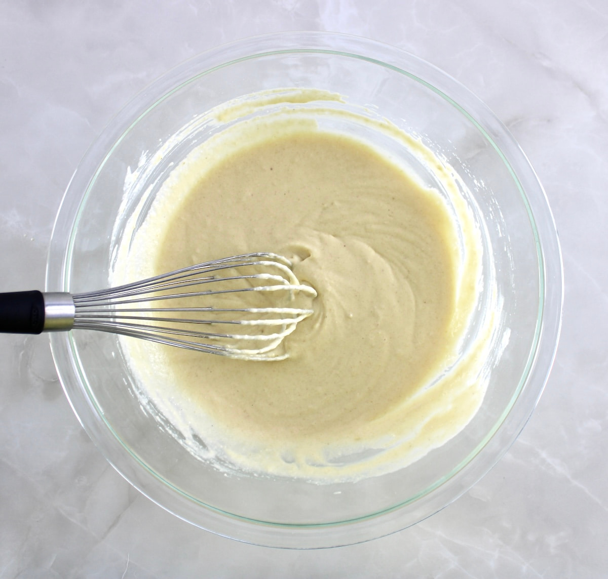 Cottage Cheese Pancakes batter in glass bowl with whisk