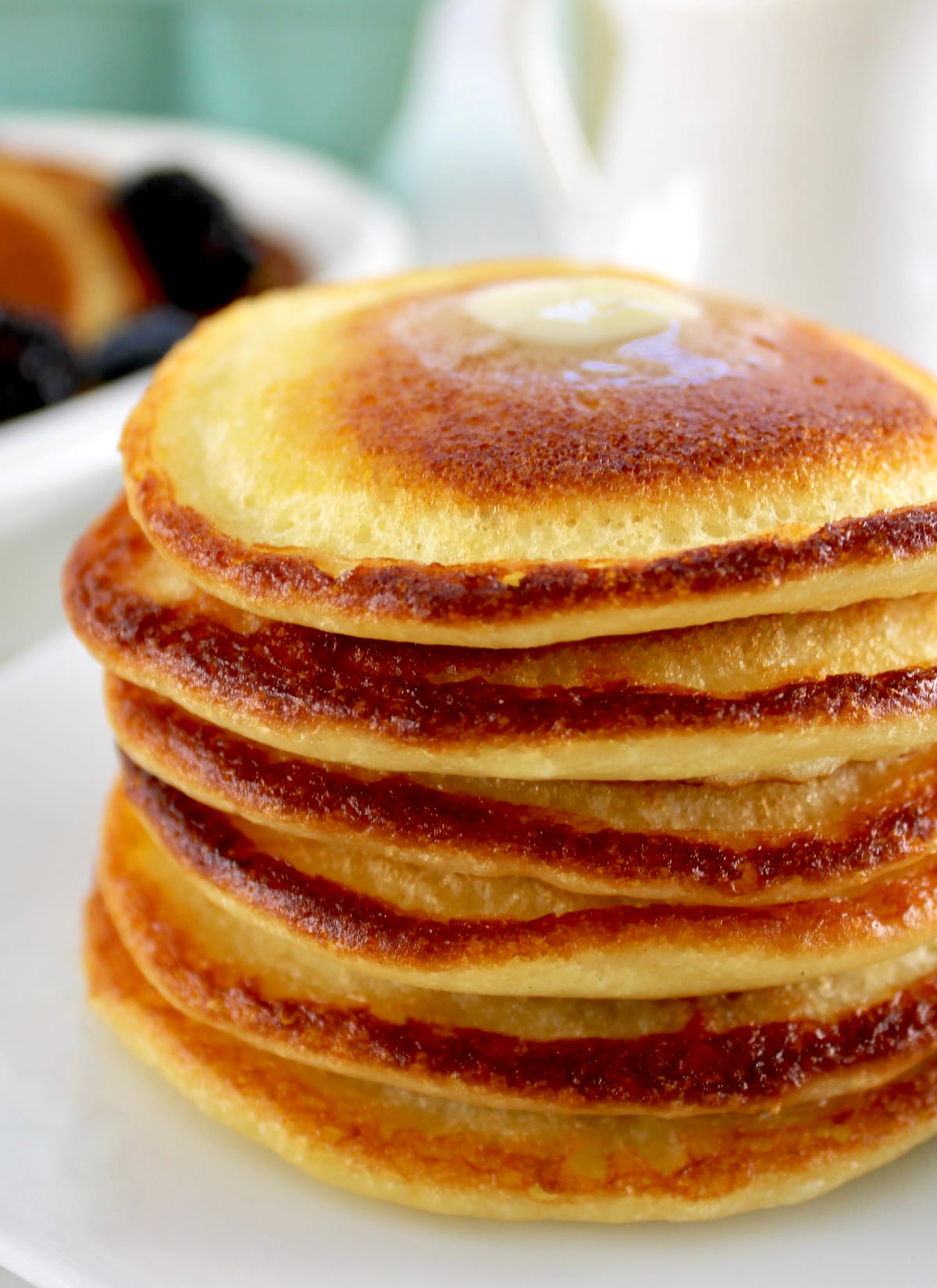 closeup of stack of Cottage Cheese Pancakes on white plate