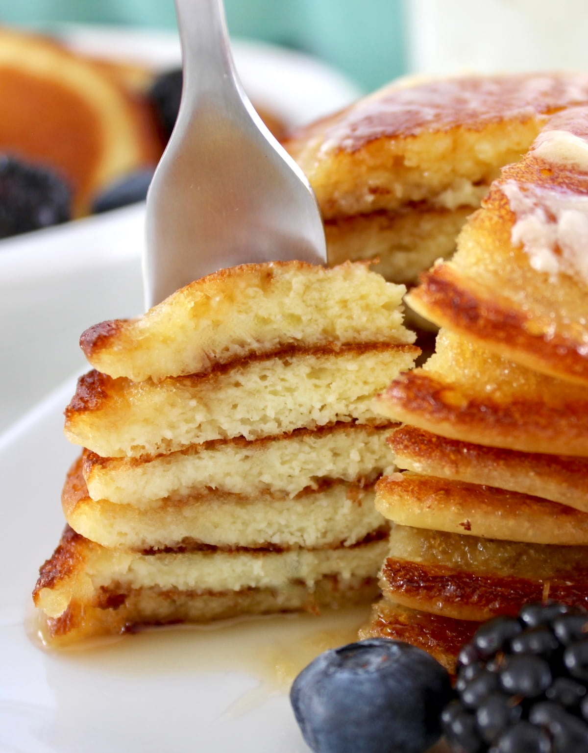 fork with bite of pancakes stacked up
