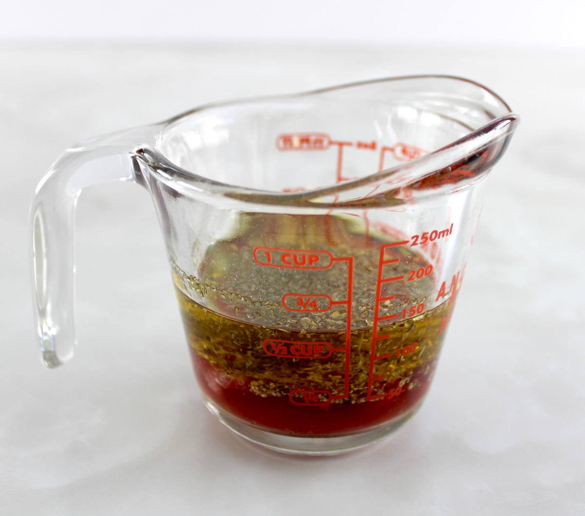 Greek Chicken Bowl marinade in glass measuring cup