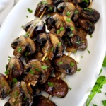 Grilled Mushroom Skewers on white oval platter