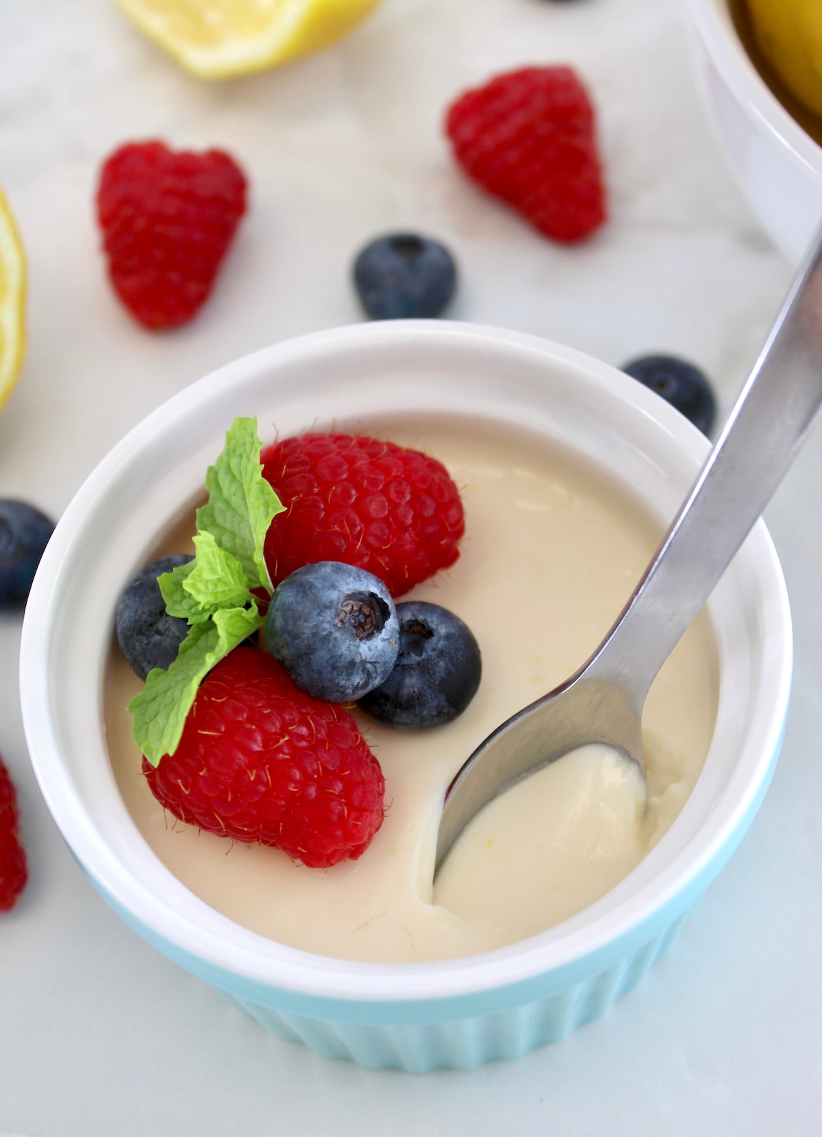 spoon digging onto ramekin with Lemon Posset