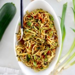 overhead view of Asian Zucchini Noodles in white oval bowl