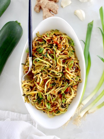 overhead view of Asian Zucchini Noodles in white oval bowl