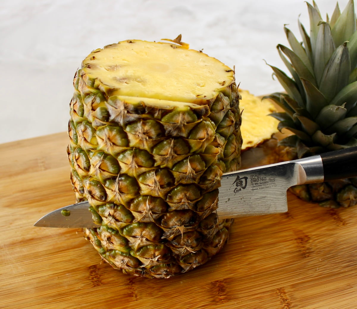 slicing pineapple on cutting board