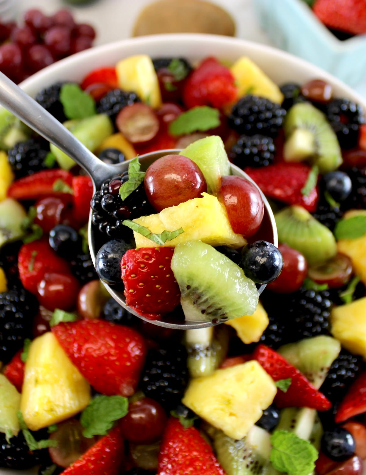 spoonful of Easy Fruit Salad held up over salad