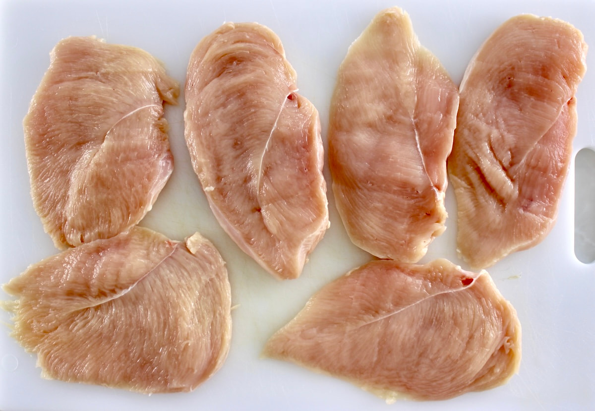 6 pieces of chicken breast on white cuttig board