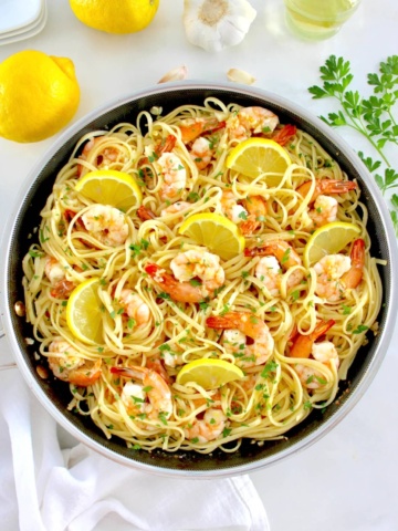 Shrimp Scampi with Linguine in skillet with lemon slices and chopped parsley