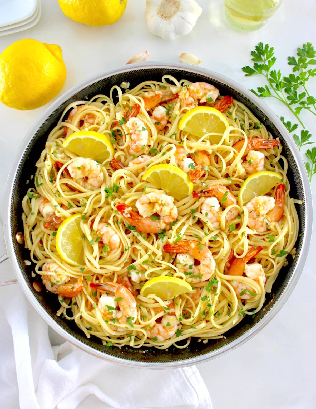 Shrimp Scampi with Linguine in skillet with lemon slices and chopped parsley