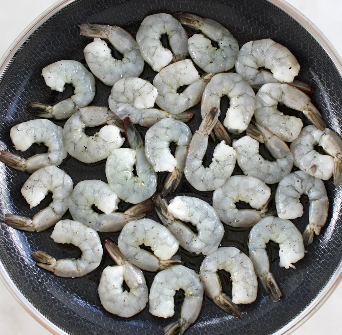 raw shrimp in skillet