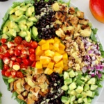 Chopped Chicken Mango Salad with ingredients in groups on white platter
