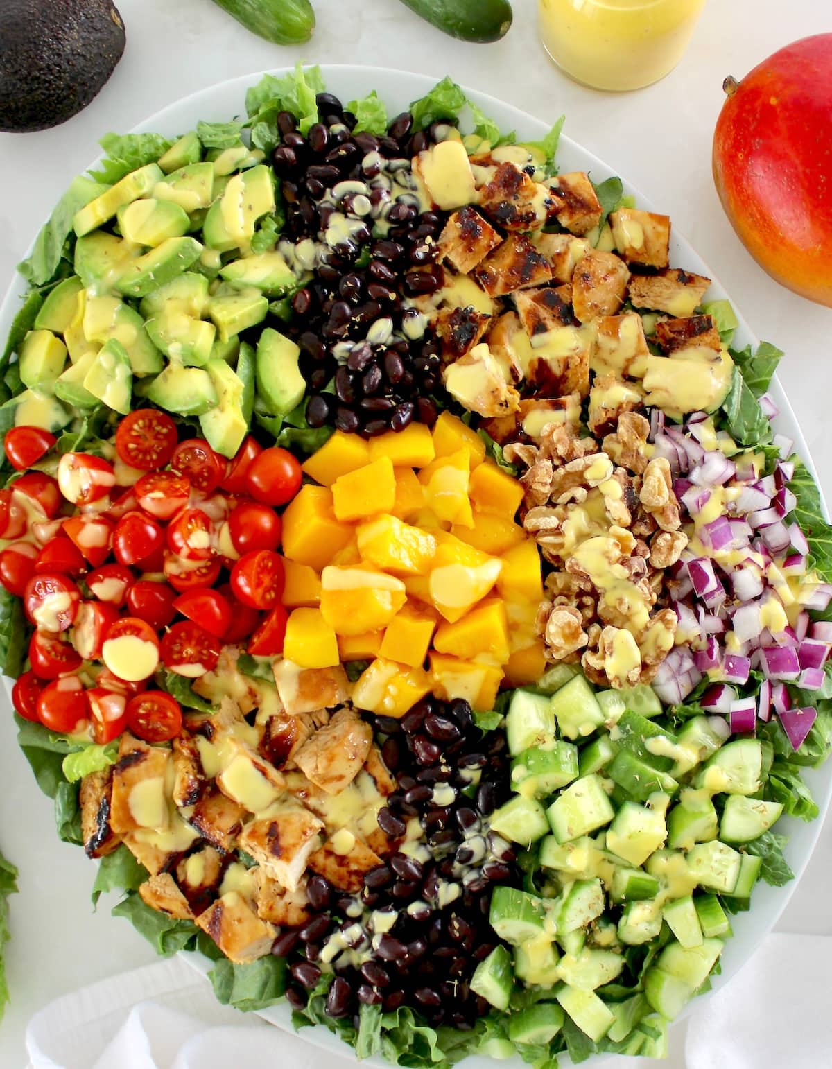 Chopped Chicken Mango Salad with ingredients in groups on white platter
