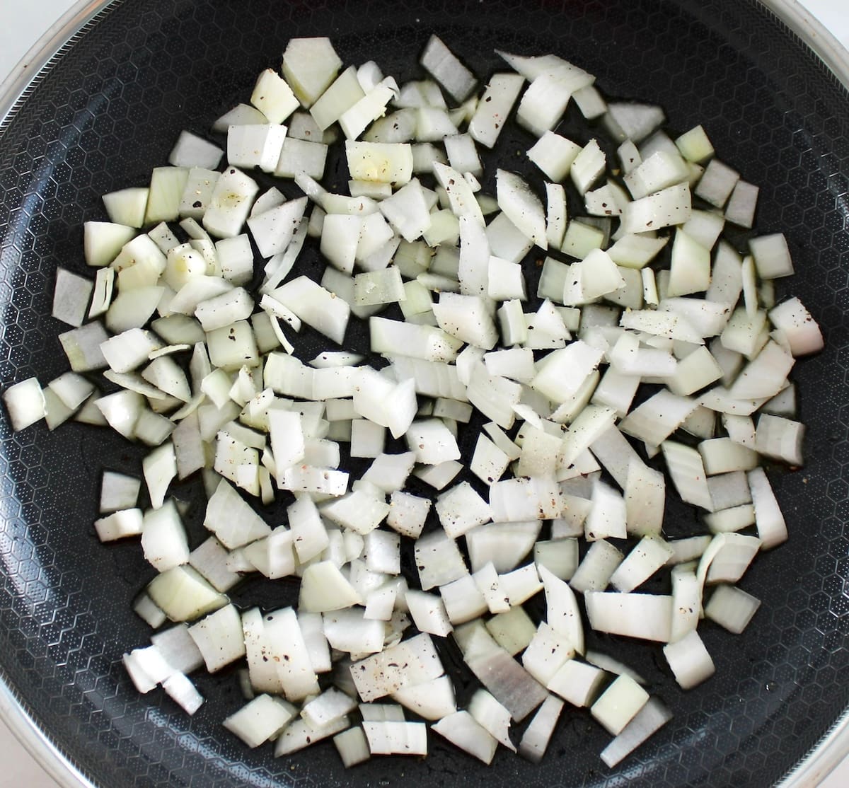 diced raw onion in skillet