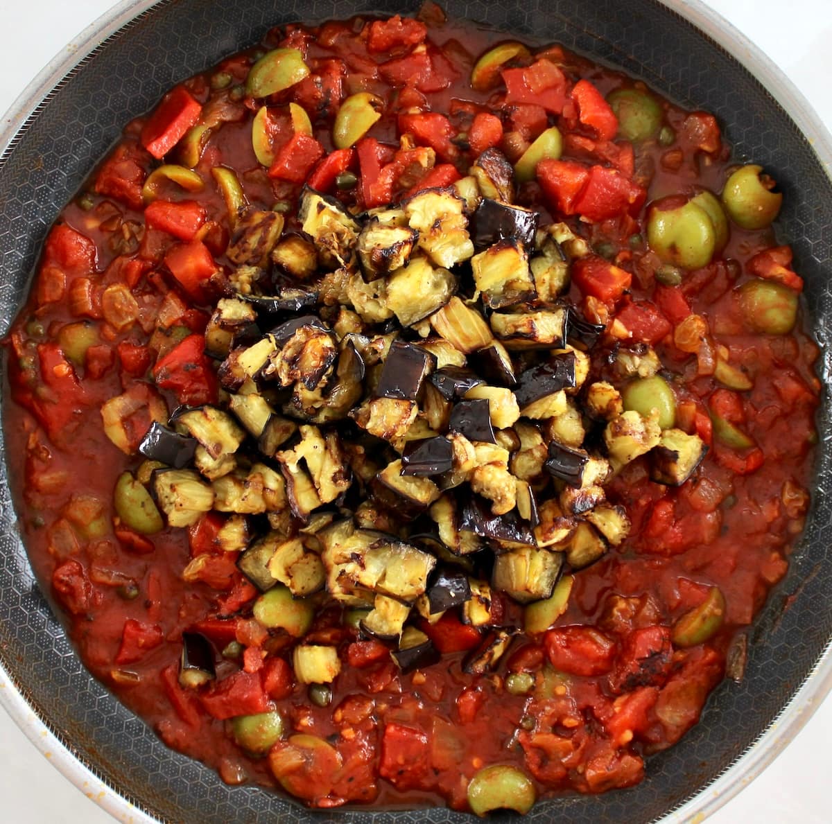 Eggplant Caponata ingredients in skillet unmixed