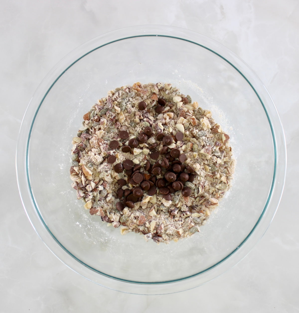 No Bake Granola Bars ingredients with chocolate chips on top in glass bowl