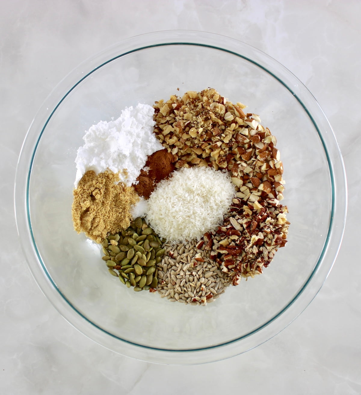 No Bake Granola Bars ingredients in glass bowl unmixed in sections