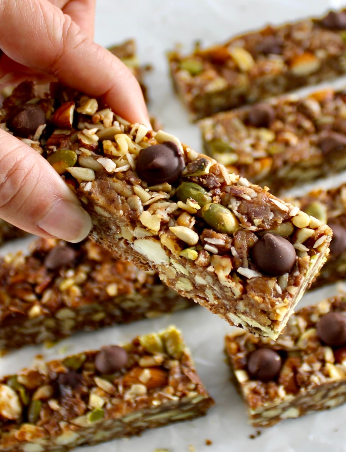 holding up No Bake Granola Bar with more bars in back