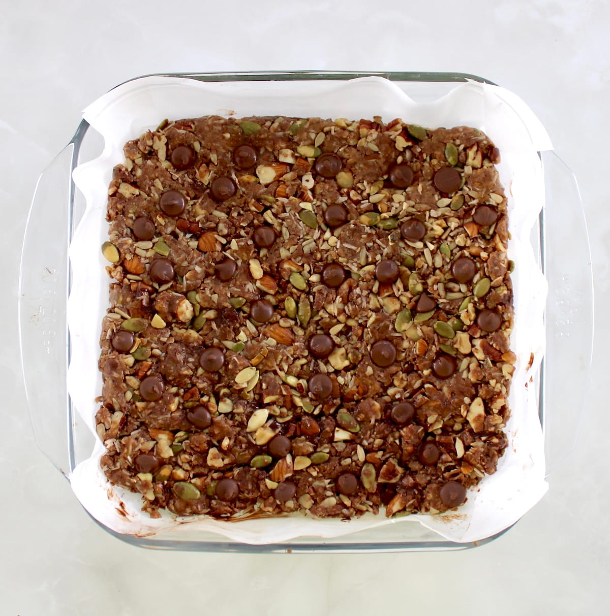 No Bake Granola Bars in parchment lined glass baking dish