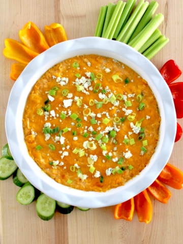 Cottage Cheese Buffalo Chicken Dip in white dish with fresh veggies around