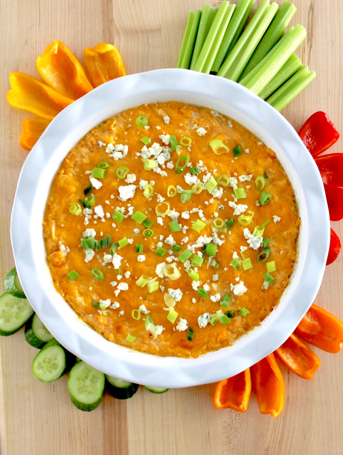 Cottage Cheese Buffalo Chicken Dip in white dish with fresh veggies around