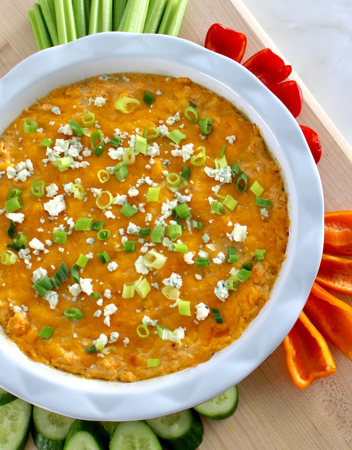 overhead view of Cottage Cheese Buffalo Chicken Dip in white pie dish with fresh veggies around