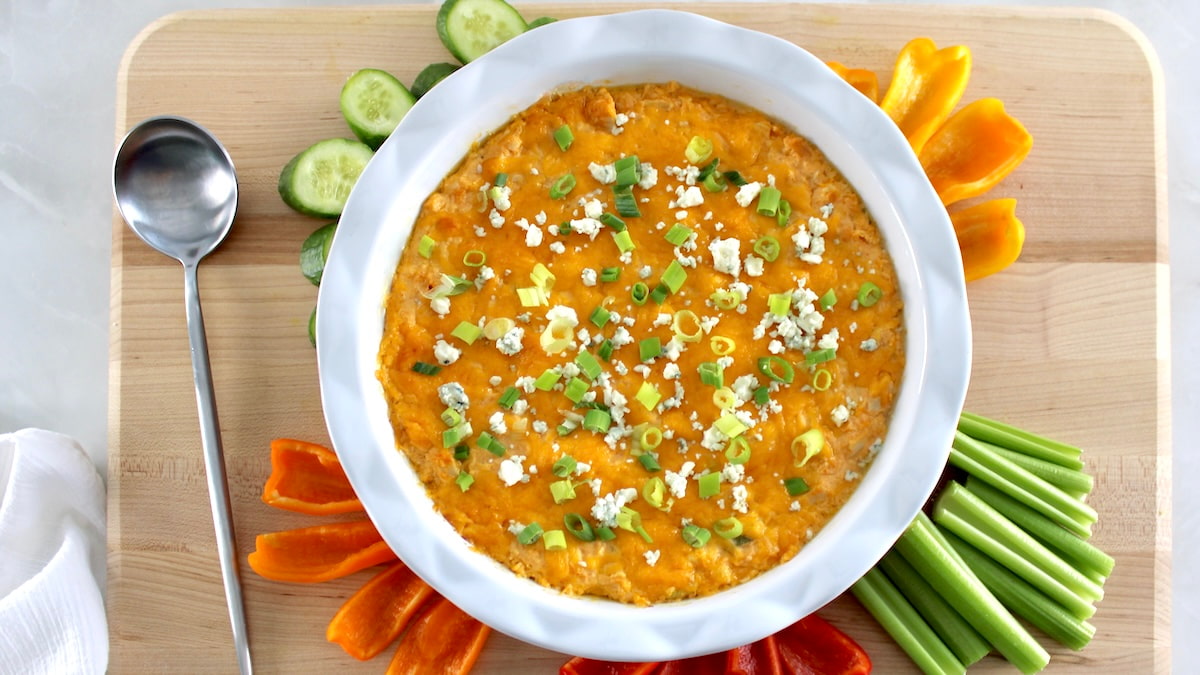 overhead view of Cottage Cheese Buffalo Chicken Dip in white pie dish with fresh veggies around