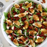 Fig and Arugula Salad in white bowl with balsamic dressing on top