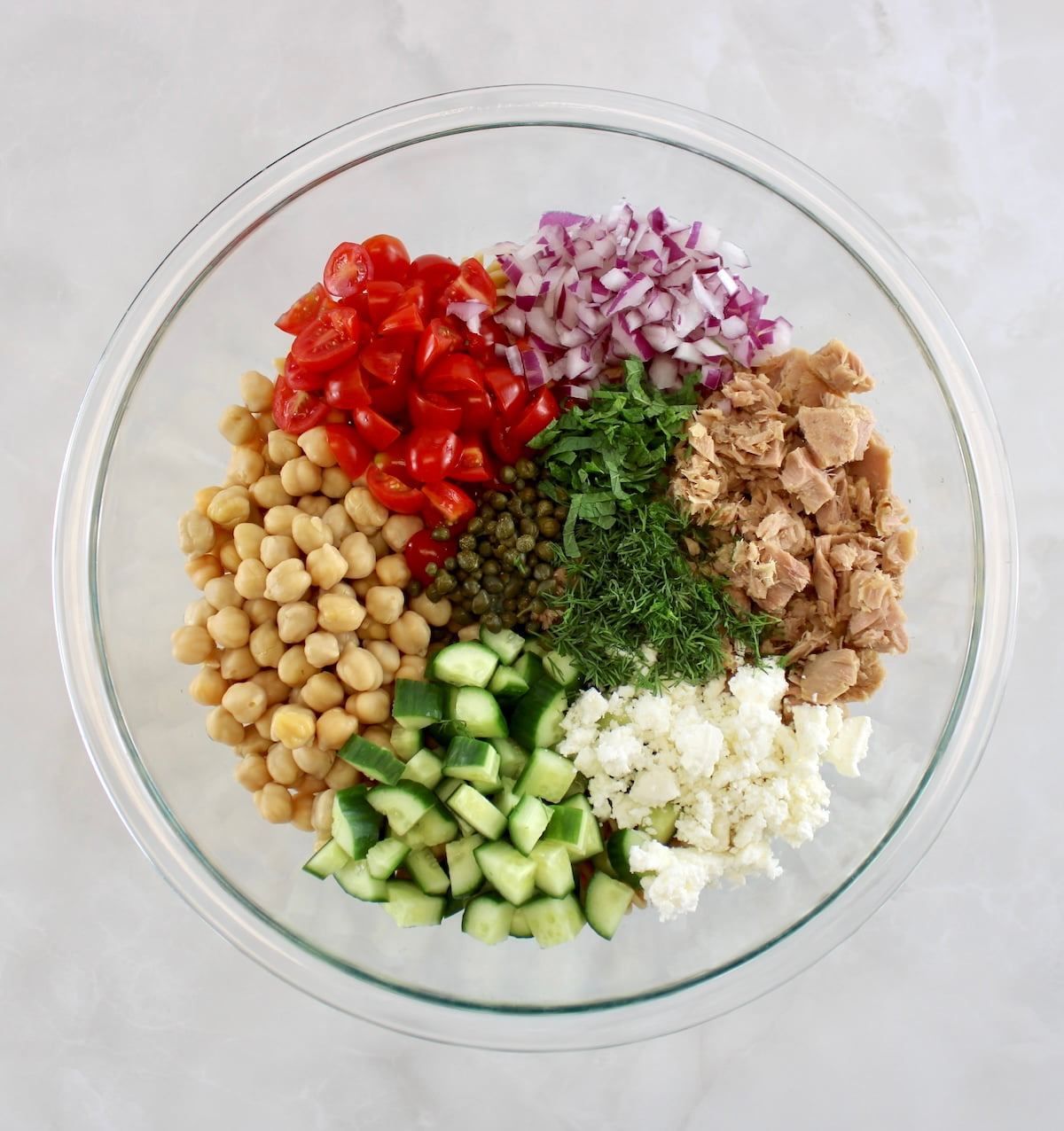 Chickpea Tuna Pasta Salad ingredients in glass bowl in sections unmixed