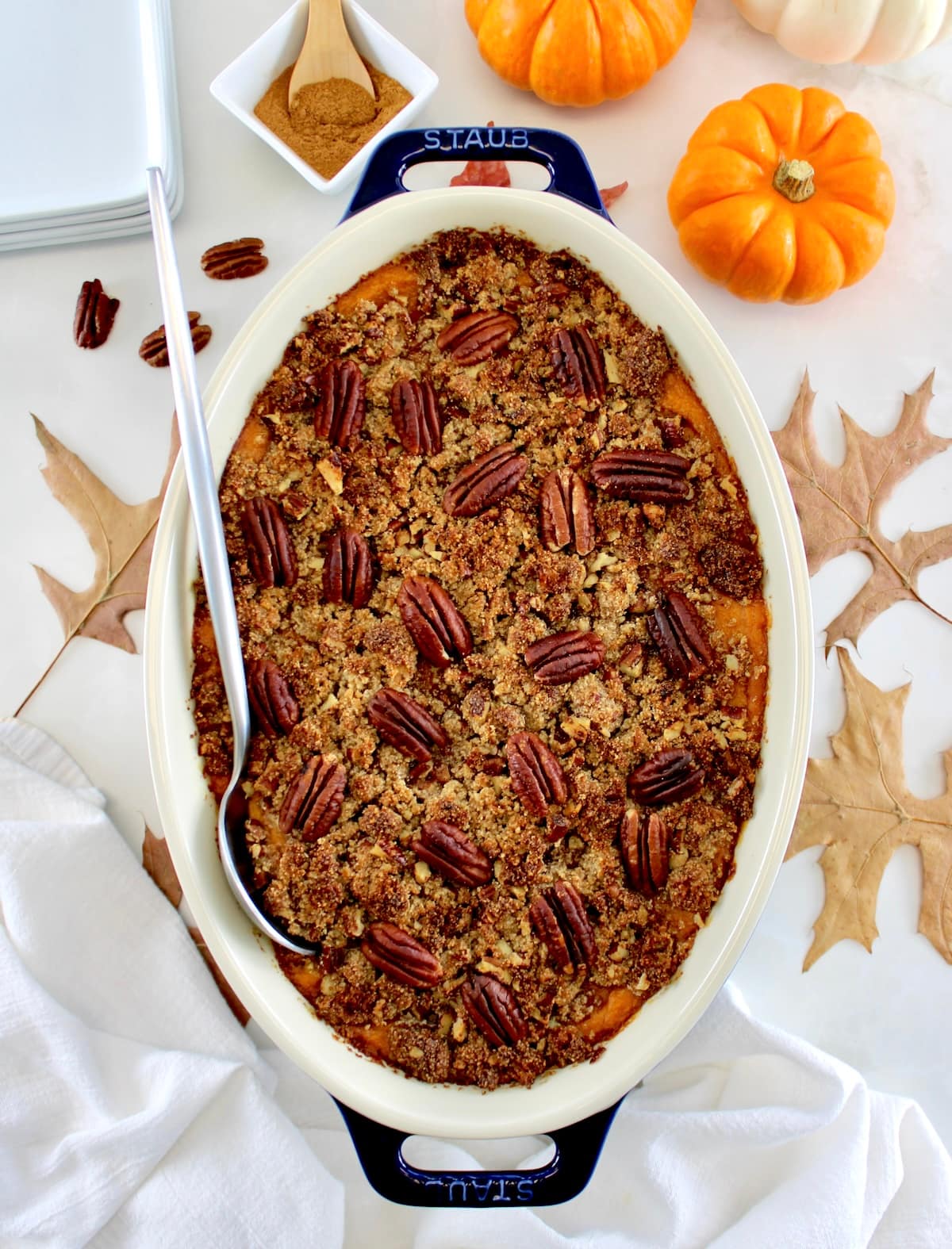 overhead view of Pumpkin Casserole in oval dish with serving spoon on side