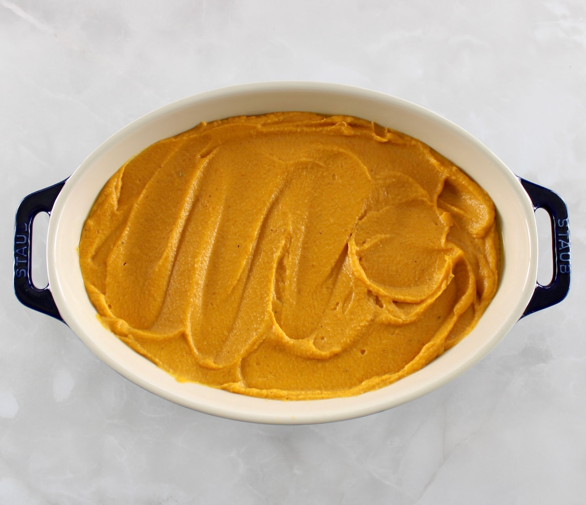 Pumpkin Casserole filling in casserole dish unbaked