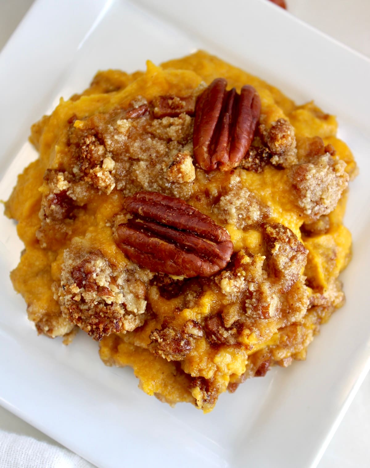 closeup of serving of Pumpkin Casserole on white dish