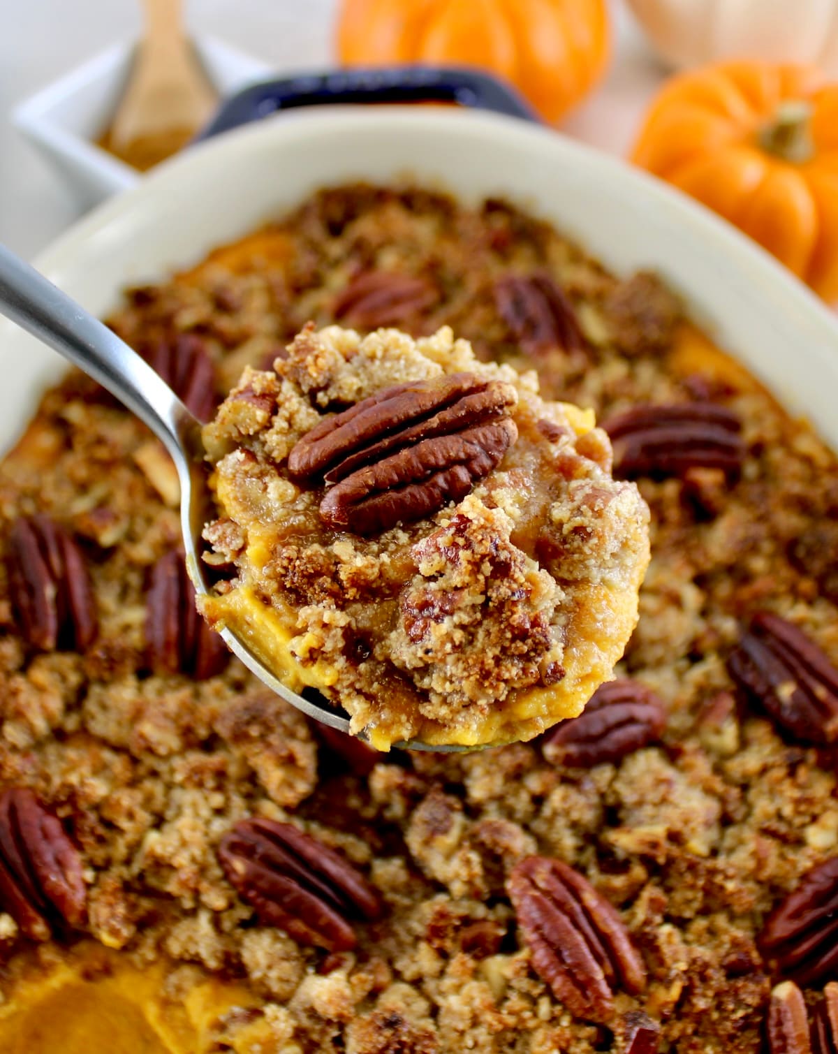 spoonful of Pumpkin Casserole held up over casserole