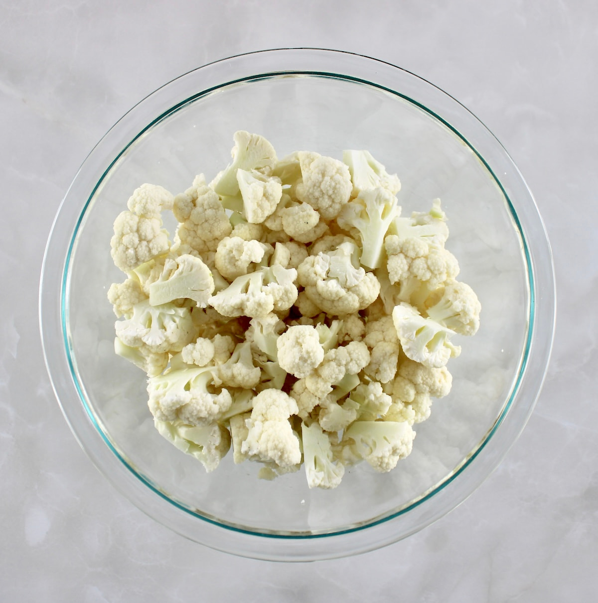 raw cauliflower florets in glass bowl